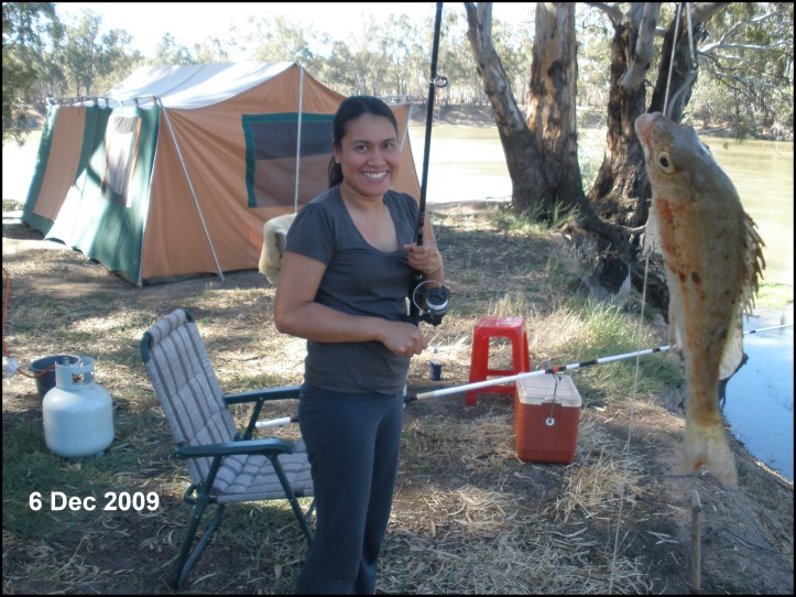 With the Big Tent in the background Mallie lands a small cod at Torrumbarry, Victoria